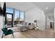 Bright living room with floor-to-ceiling windows, modern furnishings, and hardwood floors creating an inviting atmosphere at 788 W Marietta Nw St # 116, Atlanta, GA 30318