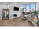Spacious living room featuring large windows, hardwood floors, and modern decor, creating an inviting and comfortable space at 788 W Marietta Nw St # 116, Atlanta, GA 30318