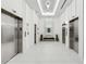 Beautifully lit lobby with mirrored wall, bench and stainless steel elevators at 788 W Marietta Nw St # 116, Atlanta, GA 30318