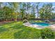 Lush backyard with a sparkling pool, providing a private outdoor oasis for relaxation and recreation at 8330 Nolandwood Ln, Villa Rica, GA 30180