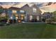 Charming exterior view of a two-story home with stone and siding details at dusk at 8330 Nolandwood Ln, Villa Rica, GA 30180