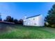 Exterior view of a home with a spacious backyard and lush greenery at dusk at 2974 Michelle Lee Dr, Dacula, GA 30019