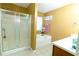 Bathroom features a shower, tub, window with natural light, and a vanity area at 2974 Michelle Lee Dr, Dacula, GA 30019