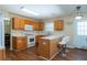 Functional kitchen area with ample counter space, oak cabinets, and modern white appliances at 2974 Michelle Lee Dr, Dacula, GA 30019