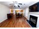 An open-concept living space showcasing a fireplace, piano, sightlines to kitchen and hardwood floors at 2974 Michelle Lee Dr, Dacula, GA 30019