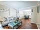 Cozy living room featuring a sofa and view to the dining room with hardwood floors and neutral paint at 2974 Michelle Lee Dr, Dacula, GA 30019