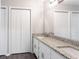 Bathroom showcasing dual sinks, granite counters and a large mirror at 5199 Mainstreet Park Dr, Stone Mountain, GA 30088