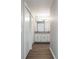 Bathroom featuring wood-look floors, double sinks, granite counters and lots of storage at 5199 Mainstreet Park Dr, Stone Mountain, GA 30088