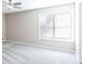 Spacious bedroom with a ceiling fan and a window with bright natural light at 5199 Mainstreet Park Dr, Stone Mountain, GA 30088
