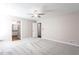 Large bedroom featuring a ceiling fan and adjacent doorways to a bathroom at 5199 Mainstreet Park Dr, Stone Mountain, GA 30088