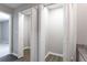 Hallway closet with bi-fold doors and laminate floors at 5199 Mainstreet Park Dr, Stone Mountain, GA 30088