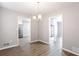 Dining room featuring hardwood floors and a modern chandelier at 5199 Mainstreet Park Dr, Stone Mountain, GA 30088
