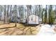 Exterior of home with mature trees and long driveway at 5199 Mainstreet Park Dr, Stone Mountain, GA 30088