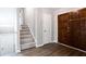 Inviting foyer featuring dark wood doors, and stairway at 5199 Mainstreet Park Dr, Stone Mountain, GA 30088