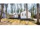 Charming home with stone accents, well-manicured lawn, and mature trees at 5199 Mainstreet Park Dr, Stone Mountain, GA 30088