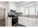Well-lit kitchen featuring white cabinets, granite countertops, and modern stainless steel appliances at 5199 Mainstreet Park Dr, Stone Mountain, GA 30088