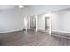 Spacious living area features neutral paint, stairs to the upper level, and luxury vinyl plank flooring at 5199 Mainstreet Park Dr, Stone Mountain, GA 30088