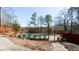 Community pool surrounded by a fence, set against a backdrop of mature trees, creating a private and serene recreational space at 5199 Mainstreet Park Dr, Stone Mountain, GA 30088