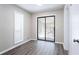 Bright room with large sliding glass doors leading to an outdoor space and wood flooring at 5199 Mainstreet Park Dr, Stone Mountain, GA 30088
