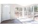 Bright sunroom with abundant windows, luxury vinyl plank flooring and access to the backyard at 5199 Mainstreet Park Dr, Stone Mountain, GA 30088