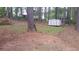 Wooded backyard featuring plenty of mature trees and an outbuilding at 7356 Caribou Trl, Riverdale, GA 30296