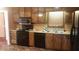Functional kitchen featuring wood cabinets, black appliances, and ample counter space at 7356 Caribou Trl, Riverdale, GA 30296
