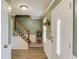 Inviting foyer with hardwood floors, staircase, and a decorative front door with glass accents at 1880 Meadowchase Ct, Snellville, GA 30078