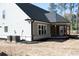Exterior view of the home featuring the covered porch, rear siding and brick foundation at 1883 Bennett Rdg, Snellville, GA 30078