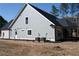 Rear exterior featuring neutral siding and a covered back porch at 1883 Bennett Rdg, Snellville, GA 30078