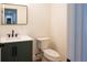 Modern powder room with sleek black fixtures, stylish mirror, and a decorative herringbone pattern on the green vanity at 1883 Bennett Rdg, Snellville, GA 30078