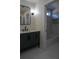 Stylish bathroom with a green vanity, modern fixtures, and tub with tiled walls, combining style and functionality at 1883 Bennett Rdg, Snellville, GA 30078