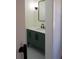 Modern bathroom featuring a green vanity, sleek mirror, and clean, minimalist design at 1883 Bennett Rdg, Snellville, GA 30078