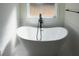 Elegant freestanding bathtub with modern black fixtures and subway tile surround creates a spa-like atmosphere at 1883 Bennett Rdg, Snellville, GA 30078
