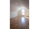 Bright bedroom features hardwood floors and a large window for natural light at 1883 Bennett Rdg, Snellville, GA 30078