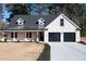 Charming one-story brick home with dormer windows and a two-car garage at 1883 Bennett Rdg, Snellville, GA 30078