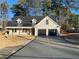 Beautiful front exterior with a concrete driveway leading to a spacious two-car garage at 1883 Bennett Rdg, Snellville, GA 30078