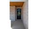 Close-up of the front door showing brick surround, hanging light and covered porch at 1883 Bennett Rdg, Snellville, GA 30078