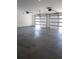 Spacious two-car garage with modern doors and a concrete floor at 1883 Bennett Rdg, Snellville, GA 30078