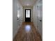 Hallway with hardwood floors, white walls, and doors leading to different areas of the home at 1883 Bennett Rdg, Snellville, GA 30078