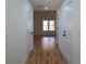 Bright hallway with hardwood floors, white walls, and paneled doors leading to different rooms at 1883 Bennett Rdg, Snellville, GA 30078
