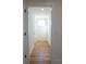 Hallway with wood flooring leading to a bright, naturally lit room at 1883 Bennett Rdg, Snellville, GA 30078