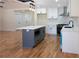 Well-lit kitchen featuring an island with a microwave and sleek white cabinets at 1883 Bennett Rdg, Snellville, GA 30078