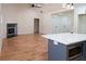 Open-concept living area with hardwood floors, fireplace, kitchen island, and modern lighting at 1883 Bennett Rdg, Snellville, GA 30078
