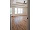 Spacious bedroom with tray ceiling, large window, and beautiful hardwood flooring, offering a serene retreat at 1883 Bennett Rdg, Snellville, GA 30078