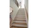 Elegant staircase with wooden treads, white risers, and black metal railings at 1883 Bennett Rdg, Snellville, GA 30078