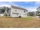 This is a view of the home's backyard and white vinyl siding at 5589 Claridge Cir, Lithonia, GA 30038