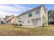 This is a view of the home's backyard with a concrete patio and white siding at 5589 Claridge Cir, Lithonia, GA 30038