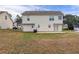 This is a view of the home's backyard with a concrete patio and white siding at 5589 Claridge Cir, Lithonia, GA 30038