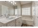 Bathroom boasts a double vanity, bathtub, and a large mirror, offering a relaxing space at 5589 Claridge Cir, Lithonia, GA 30038