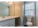This is a bright bathroom featuring a vanity with drawers, a large mirror, and a toilet by the window at 5589 Claridge Cir, Lithonia, GA 30038